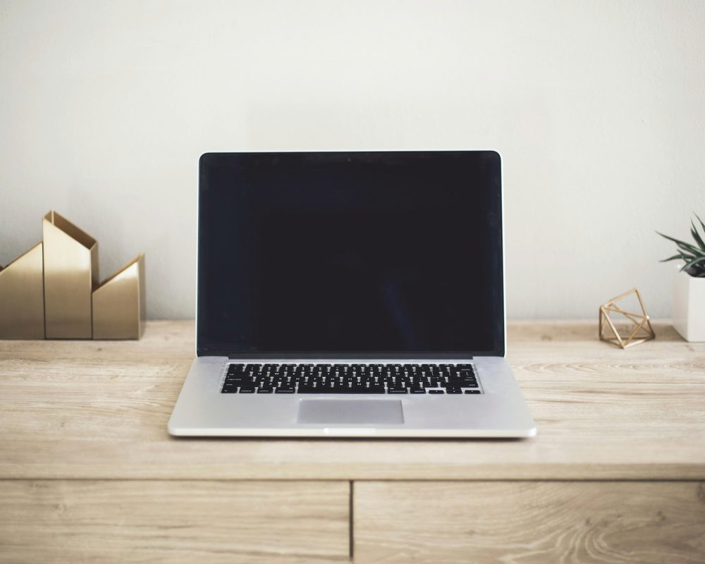 Laptop on a wooden desk, get your key